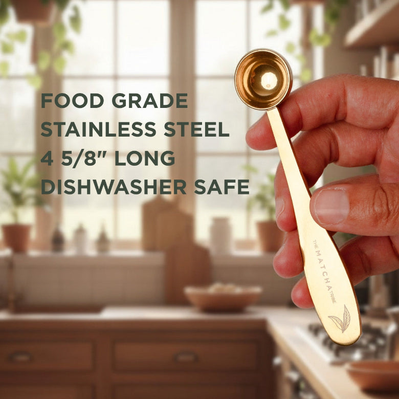 Gold measuring spoon held by a hand with kitchen background